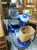 An Invacare trike mobility scooter with charger