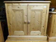 A pine television stand and pine cupboard,