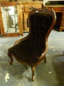 An upholstered carved nursing chair