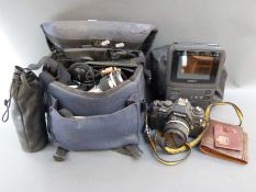 A Nikon F-300 SLR camera with Nikkor 28mm 1:2.8, 55mm 1:2.8 macro and 135mm 1:2.