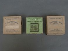 A box of lithographic magic lantern slides depicting life in Africa showing village life and a