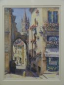Angela Cash watercolour St Emillion street scene with spire beyond, signed and titled to lower edge,
