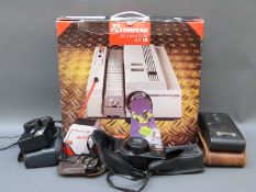 A Reflecta slide projector and three various cameras including a folding example