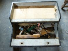 A vintage tool chest containing planes, saws,