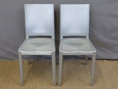 A pair of Emeco by Starck aluminium Hudson chairs