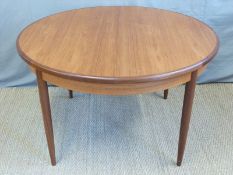A retro G Plan circular dining table with extra leaf (H74 x D124cm)