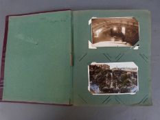 A postcard album containing approximately 200 early-mid 20thC examples,
