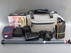 A collection of cameras, lenses and accessories to include Olympus OM 20, Fuiji DL25 35mm,