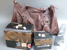 Olympus OM-2 camera body and various accessories in leather bag