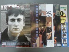 A collection of vintage 1980s/90s Beatles calendars, trade cards and albums, loose cigarette cards,