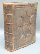 A Victorian leather bound illustrated Bible with brass clasps