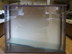 A display case with sliding perspex front and three slide in shelves