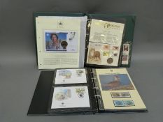 A coin and stamp album and a WWF stamp album