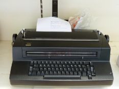 A vintage IBM 'golfball' typewriter model 670 with extra balls and cover