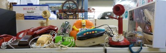 A large collection of retro telephones to include novelty and coloured examples