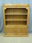 A pine bookcase with cupboard under (H125 x W110 x D24cm)