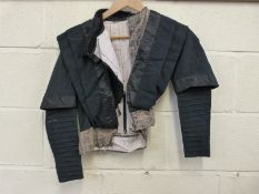 A Victorian ladies mourning jacket with lace collar and decorative lining