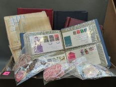 Two boxes containing a large quantity of stamps and albums and an albums of first day covers