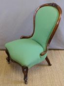 A 19thC mahogany spoon back chair with serpentine front raised on carved legs and brass castors