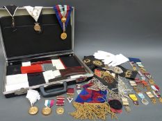 A briefcase containing a quantity of Masonic regalia including a silver gilt example,