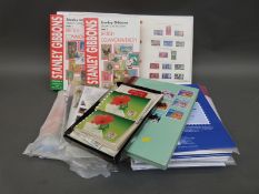 A box of sundries including catalogues, album supplements, Hawid mounts, loose stamps,