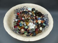 A large ceramic bowl containing a large quantity of various vintage buttons