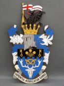 A heavy bronze and enamel armorial plaque with Latin motto 