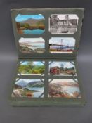 A large postcard album of black and white and colour postcards,