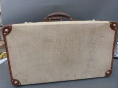 Two Ministry marked suitcases one stamped A G & Co Ltd,