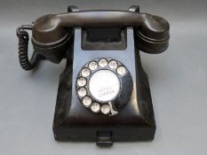 A vintage bakelite telephone,