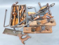 A quantity of vintage woodworking tools to include planes, drill, saw,