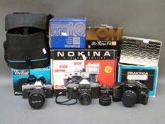 A quantity of SLR cameras and accessories to include Canon EOS 300, Olympus OM10, Pracktica etc,