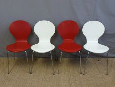 A set of four retro dining chairs raised on chrome legs