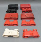 Six pairs of Kershaw opera glasses in red, black and white finish,