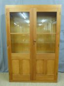 A glazed pine bookcase (H183 x W122 x D28cm)