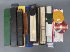 Approximately twenty slide rules including British Thornton, Faber Castell, Blundell,