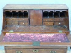 A 19thC mahogany bureau with two over three graduated drawers and fitted interior raised on bracket
