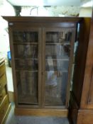 A tall glazed bookcase with adjustable shelves (H152 x W97 x D33cm)