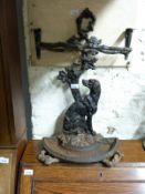 A cast iron figural seated dog umbrella/stick stand with semi circular drip tray in the