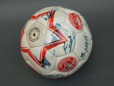 A signed Aberdeen Football Club football together with a vintage brown leather ball