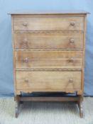 An Arts and Crafts oak chest of four graduated drawers with craved detail,