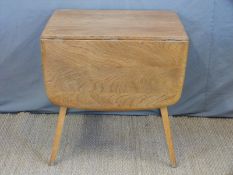 A retro Ercol light elm table (H71 x W138 x D73cm)