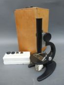 A cased Russian WM-1 microscope with lenses and slide
