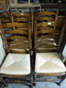 A set of four Brights of Nettlebed oak ladder-back chairs
