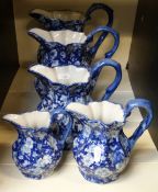 Five blue and white graduated jugs