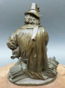 A 19thC bronze of a labourer at harvest time sitting on a wheat sheaf with bagpipes,