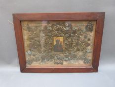 A 17th/ 18thC Hungarian reliquary panel with a painted icon to the centre surrounded by