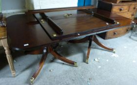 A large reproduction mahogany dining table in the Regency style (H74 x W114 x min L204 x max