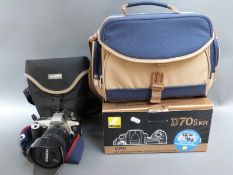Cameras and lenses including Canon EOS 500 with Tamron 28-200mm lens,