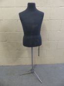 A modern male mannequin on tripod stand,